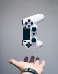 a hand holding a gaming controller